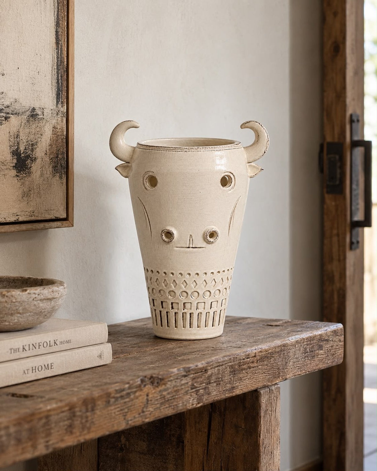 Toro bull vessel styled on a rustic wood console