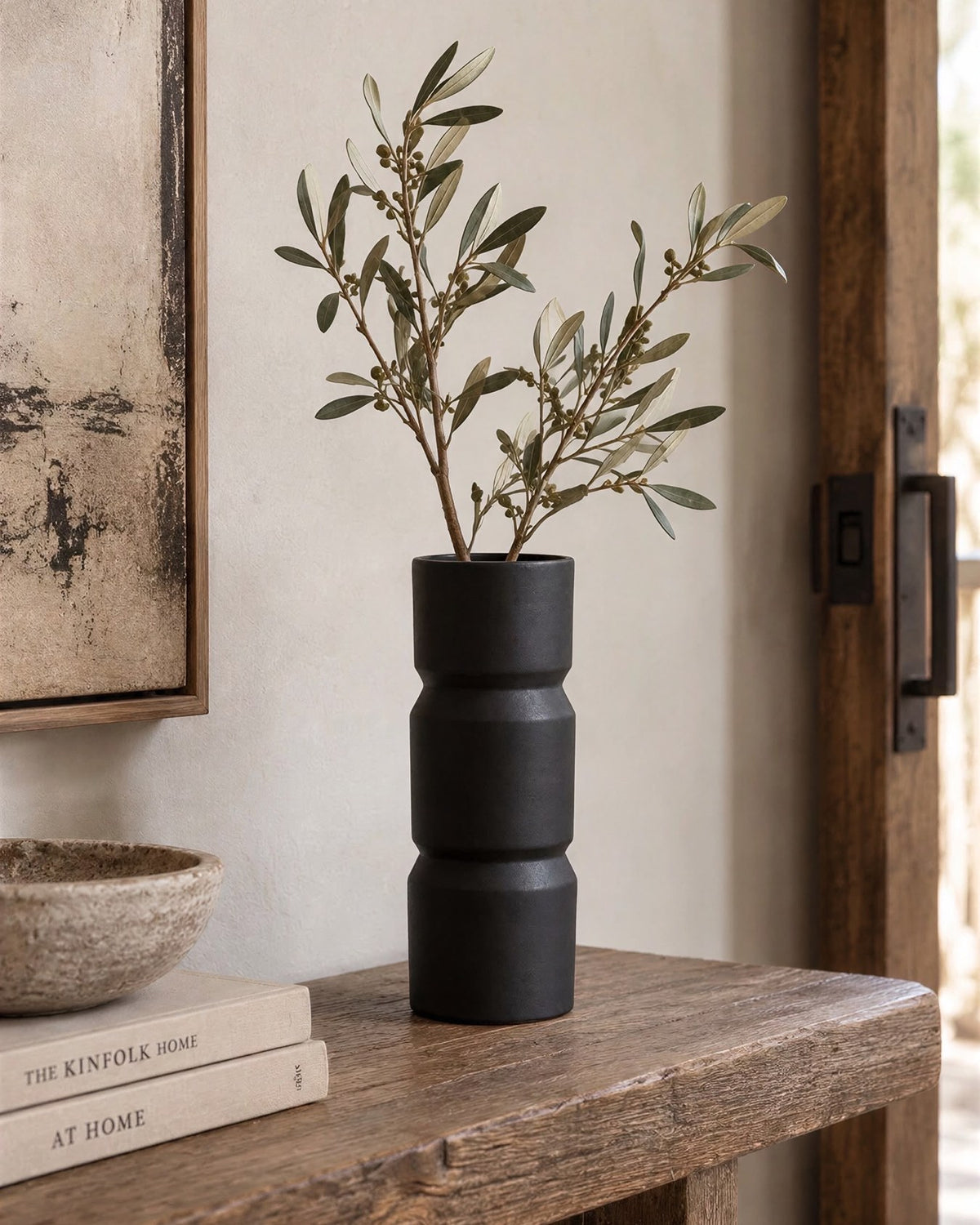 Siren black vessel styled with branches on a rustic wood console (branches not included)